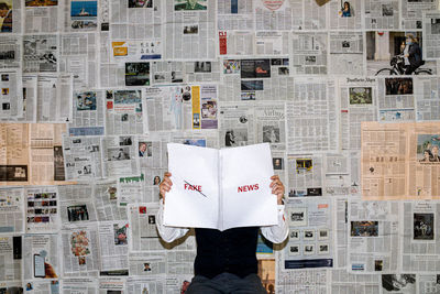 Midsection of person holding book