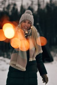 Portrait of young woman standing in snow