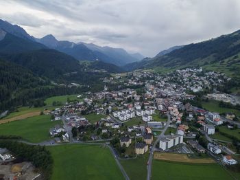 Scenic view of townscape and mountains against sky