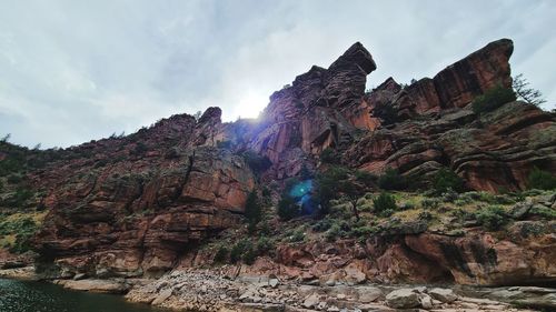 Low angle view of rock formations against sky