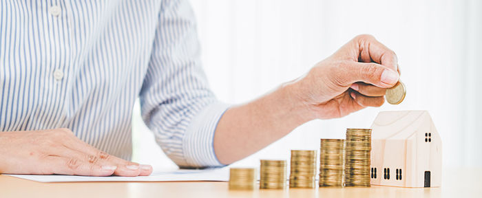 Cropped image of hand with hat on table