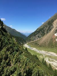 Scenic view of mountains against clear blue sky