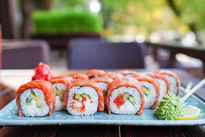 Sushi roll with salmon and shrimp tempura on plate