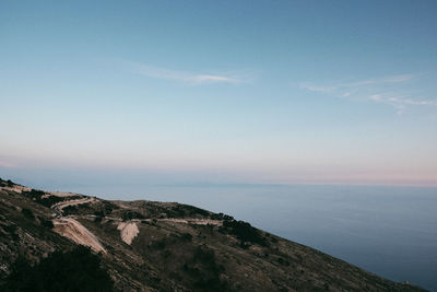Scenic view of sea and mountains against sky