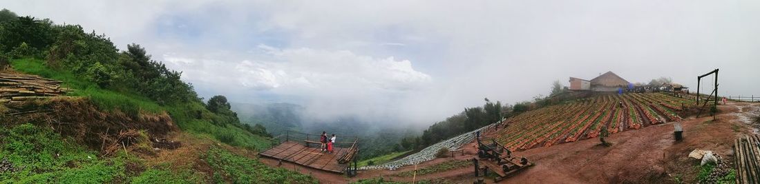 Panoramic view of people on mountain against sky