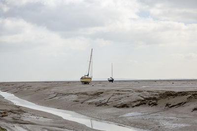 Fisherman boats stuck on the beach in low tide period in leigh-on-sea, uk.