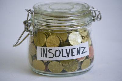 Close-up of coins in glass container