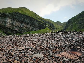 Surface level of stones on land against sky