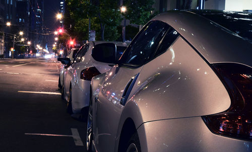 Cars in illuminated city at night