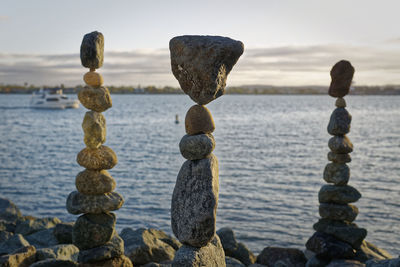 Close-up of rocks in sea against sky