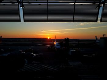 Silhouette city against sky during sunset