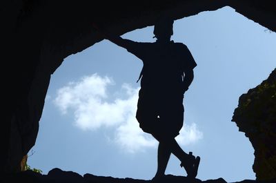 Low angle view of silhouette woman against sky