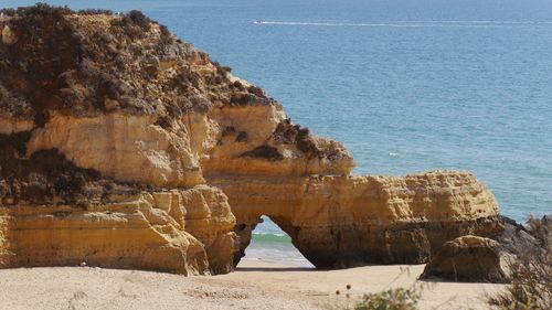 Scenic view of sea against sky with natural arch at algarve 