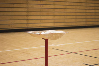 Close-up of table on floor against wall