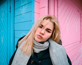 Portrait of beautiful woman standing against wall