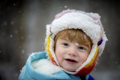 Close-up portrait of cute girl in snow