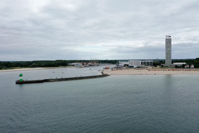 Scenic view of sea against sky in city