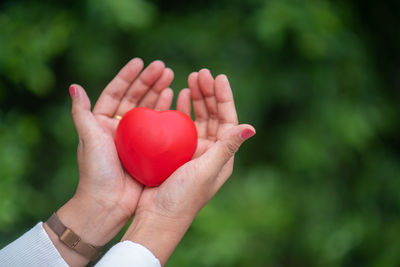 Close-up of hand holding red heart