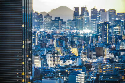 High angle view of illuminated buildings against sky in city