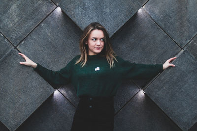 High angle portrait of woman standing on tiled floor