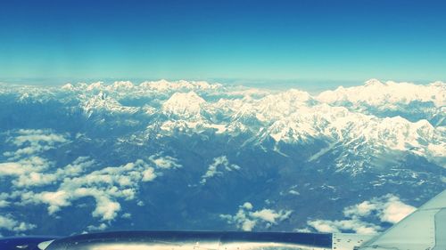 Scenic view of mountains against blue sky