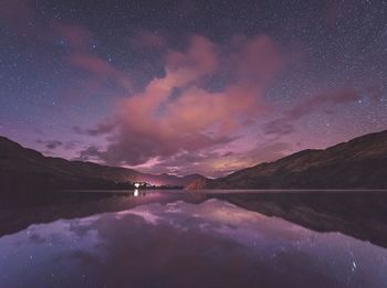 Scenic view of calm lake against star field