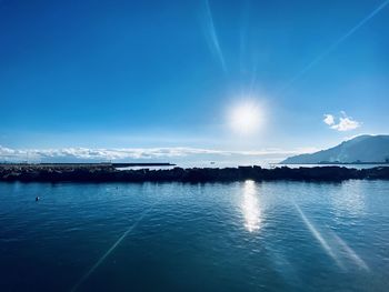 Scenic view of sea against blue sky