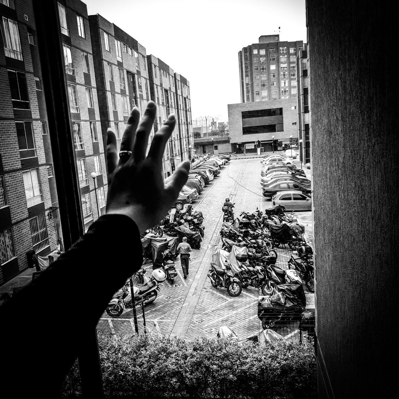 MIDSECTION OF PERSON AGAINST BUILDINGS IN CITY AGAINST SKY