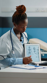 Doctor showing digital tablet in clinic 