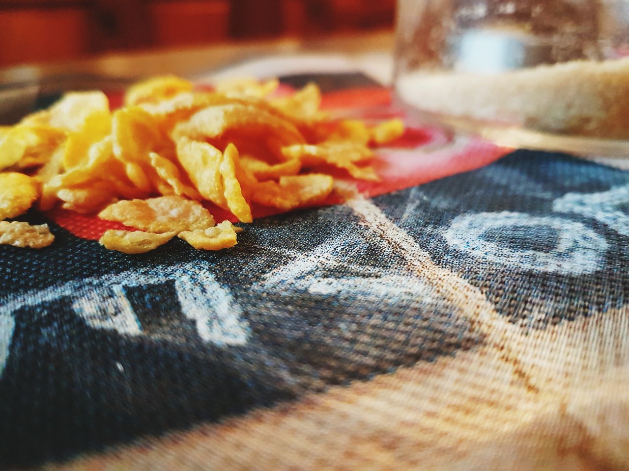 food and drink, selective focus, close-up, food, table, indoors, still life, textile, no people, freshness, drink, refreshment, snack, ready-to-eat, glass, pattern, yellow, wood - material, potato, focus on foreground