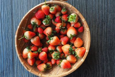 High angle view of strawberries in basket on table