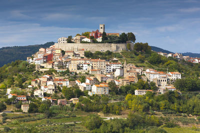 Buildings in town against sky