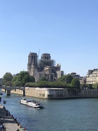 View of buildings in city against clear blue sky