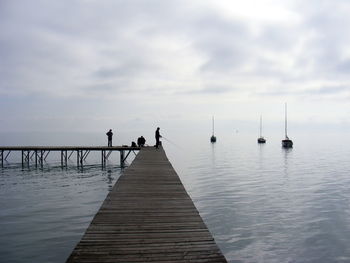 Pier over sea against sky