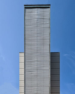 Low angle view of modern building against blue sky