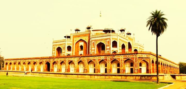 architecture, built structure, building exterior, arch, famous place, travel destinations, tourism, facade, dome, architectural column, travel, clear sky, history, international landmark, incidental people, sky, tourist, low angle view, grass, capital cities