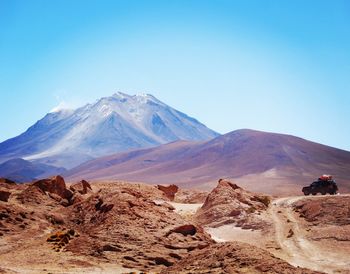 Scenic view of snowcapped mountain against blue sky