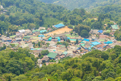 High angle view of houses and trees on field