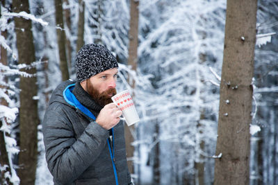 Portrait of young man drinking glass