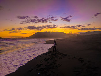 Scenic view of beach against sky during sunset