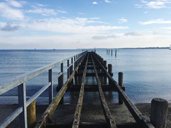 Pier over sea against sky