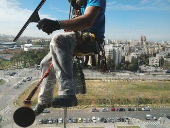 Full length of man and buildings against sky in city