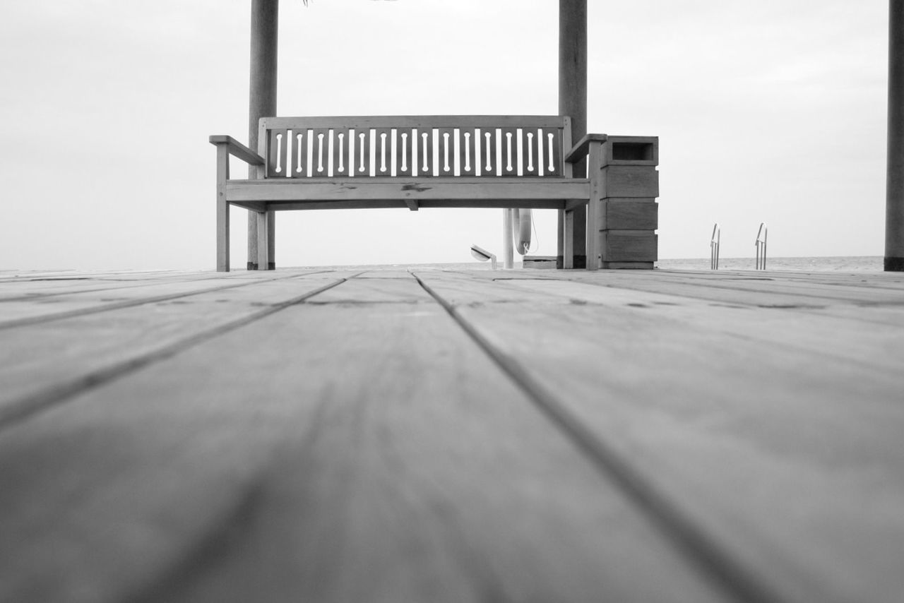 EMPTY BENCHES AGAINST SKY