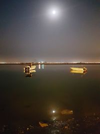 Scenic view of sea against sky at night