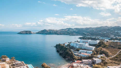 High angle view of sea and buildings against sky