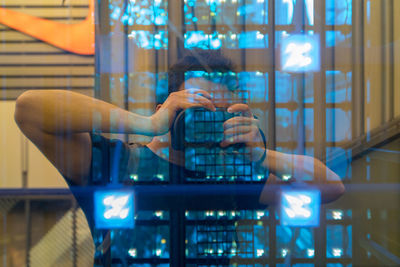 Man photographing through glass