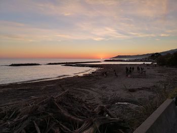 Scenic view of beach against sky during sunset