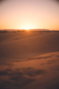 Scenic view of desert against sky during sunset