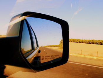 Close-up of side-view mirror of car