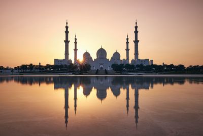 Reflection of building in lake at sunset